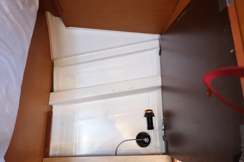 Slide: The Image of 2018 Jeanneau Sun Odyssey 389 interior compartment with visible wiring and components. - 150