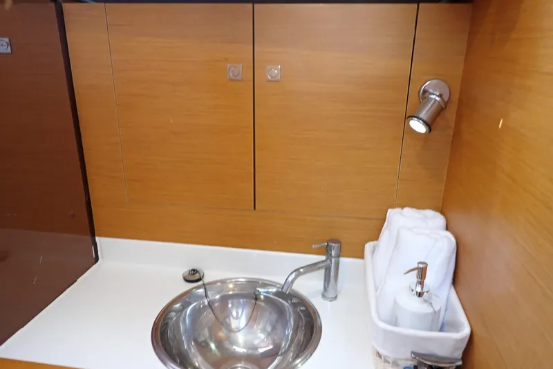 Slide: The Image of Modern bathroom sink area on 2018 Jeanneau Sun Odyssey 389 yacht. - 170