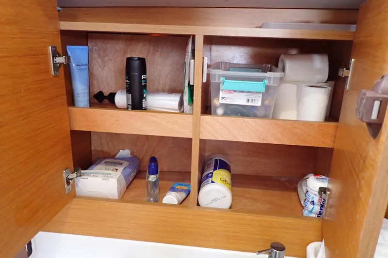 Slide: The Image of Wooden bathroom cabinet on Jeanneau Sun Odyssey 389 yacht, stocked with toiletries and essentials. - 171