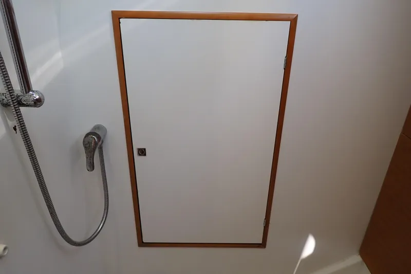 Slide: The Image of Shower area on 2018 Jeanneau Sun Odyssey 389 yacht with wooden-framed door. - 180