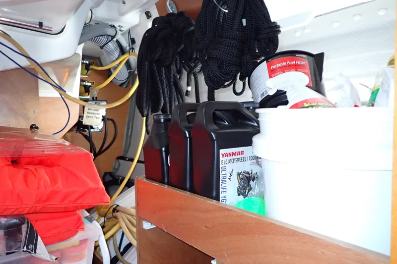 Slide: The Image of Storage area on 2018 Jeanneau Sun Odyssey 389 with ropes, fuel filter, and antifreeze. - 182