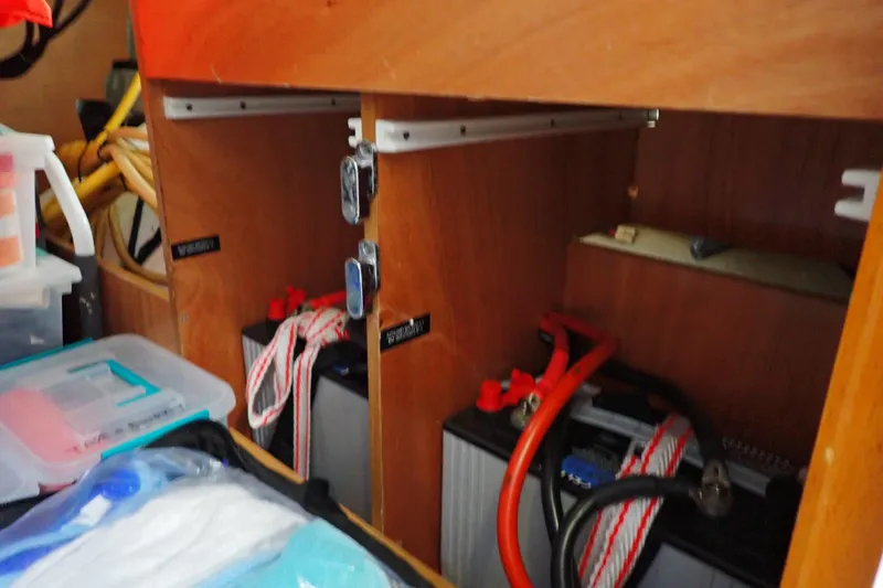 Slide: The Image of Battery compartment of a 2018 Jeanneau Sun Odyssey 389 sailboat, featuring organized storage. - 183