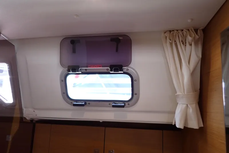Slide: The Image of Interior view of 2018 Jeanneau Sun Odyssey 389 yacht window with curtain. - 188