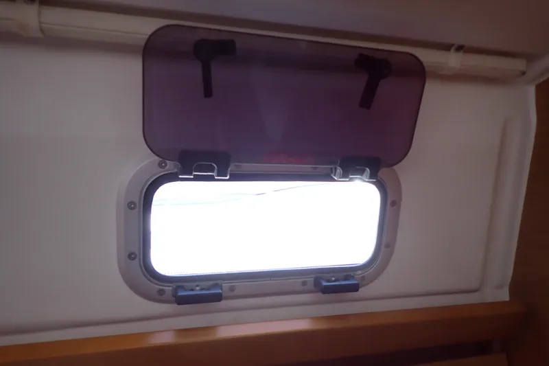 Slide: The Image of Cabin window of 2018 Jeanneau Sun Odyssey 389 yacht with open hatch. - 192