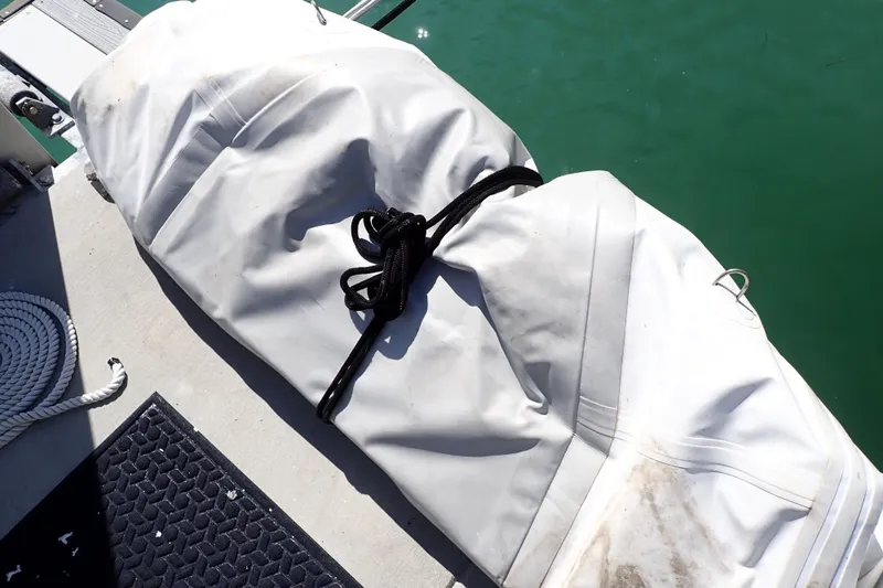 Slide: The Image of Covered equipment on Jeanneau Sun Odyssey 389, 2018, docked by green water. - 194