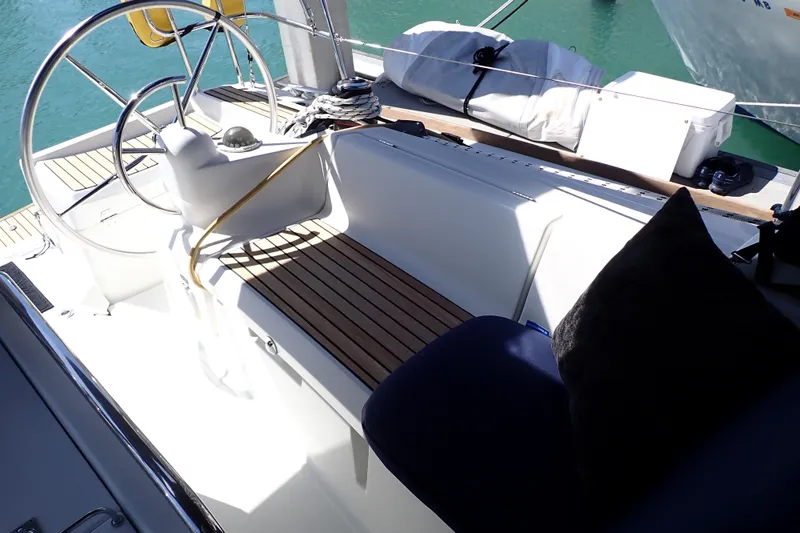 Slide: The Image of Cockpit of 2018 Jeanneau Sun Odyssey 389 sailboat with teak seating and steering wheel. - 31