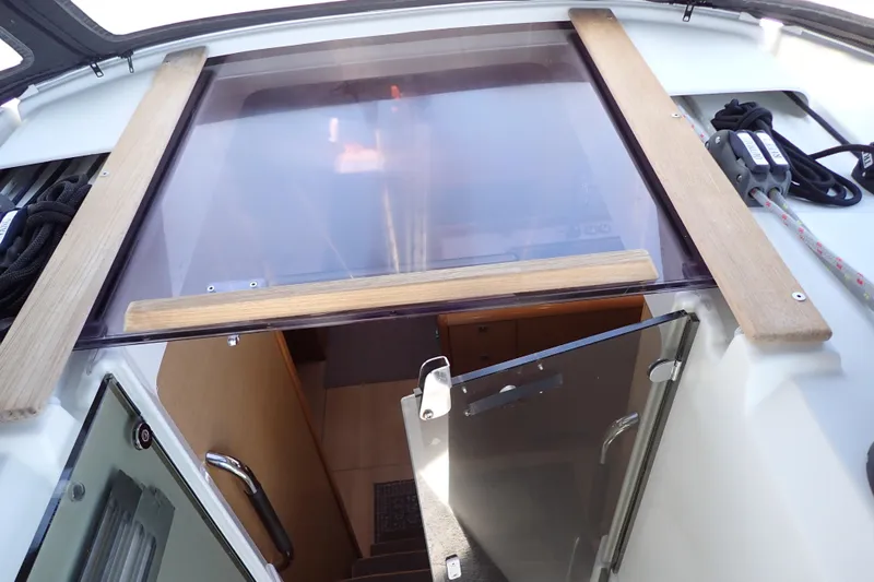 Slide: The Image of 2018 Jeanneau Sun Odyssey 389 yacht interior entrance with wooden and glass elements. - 33