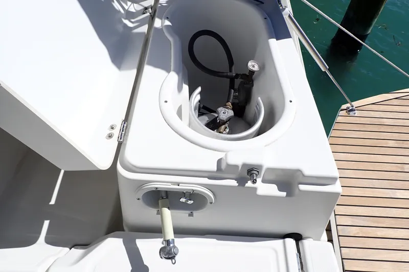 Slide: The Image of Anchor locker on 2018 Jeanneau Sun Odyssey 389 sailboat, docked by wooden pier. - 34