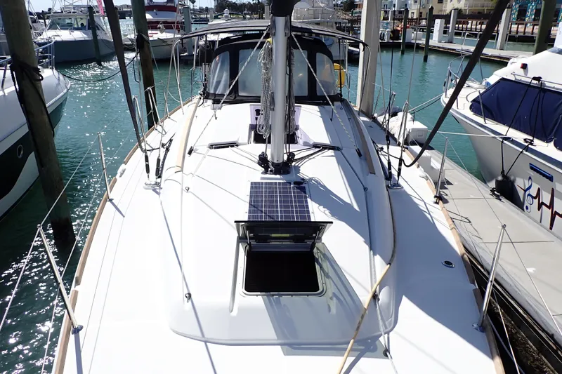 Slide: The Image of 2018 Jeanneau Sun Odyssey 389 sailboat docked at marina, featuring solar panel on deck. - 4