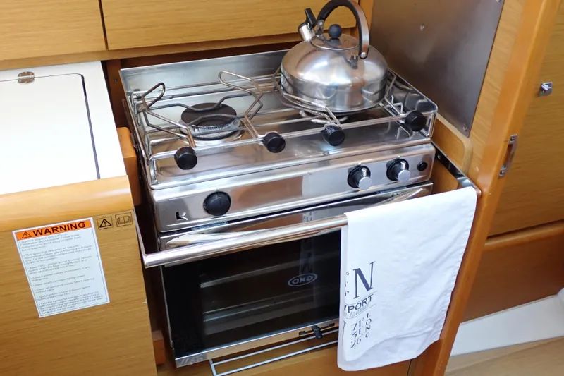 Slide: The Image of Galley kitchen in 2018 Jeanneau Sun Odyssey 389 with stove and kettle. - 47