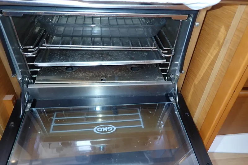 Slide: The Image of Oven interior on 2018 Jeanneau Sun Odyssey 389 yacht, featuring racks and glass door. - 48