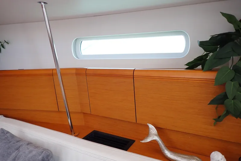 Slide: The Image of Interior of 2018 Jeanneau Sun Odyssey 389 yacht with wooden paneling and decorative elements. - 57
