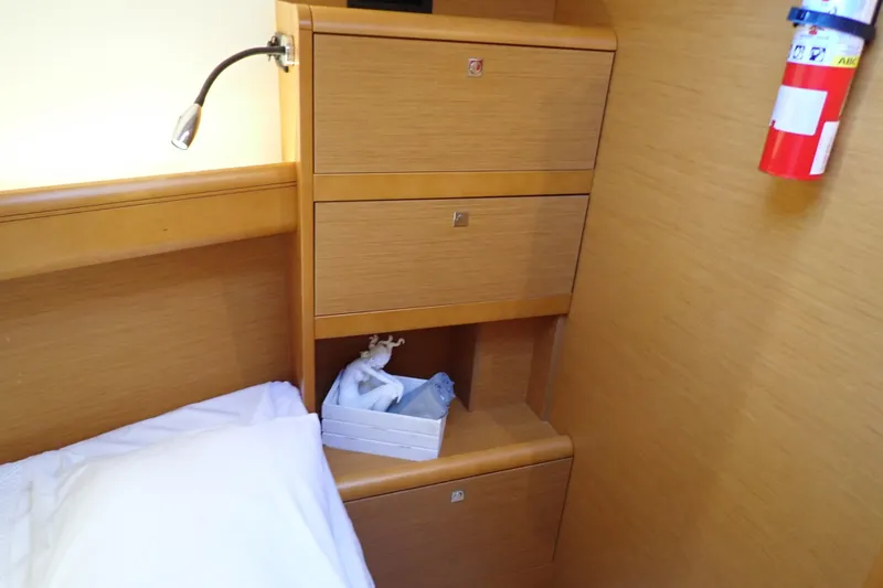 Slide: The Image of Interior cabin of 2018 Jeanneau Sun Odyssey 389 with wooden storage and fire extinguisher. - 59
