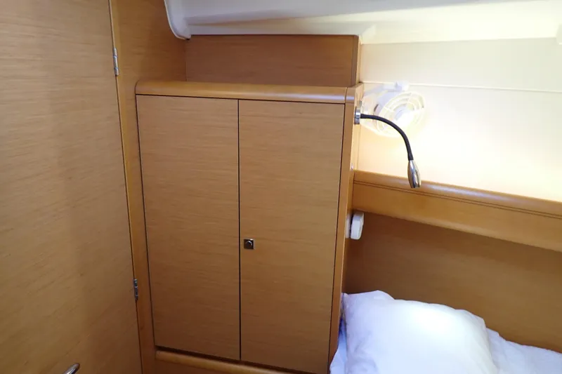 Slide: The Image of Interior cabin of 2018 Jeanneau Sun Odyssey 389 yacht with wooden cabinetry and reading light. - 60