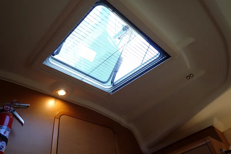 Slide: The Image of Interior view of 2018 Jeanneau Sun Odyssey 389 yacht with skylight and fire extinguisher. - 61
