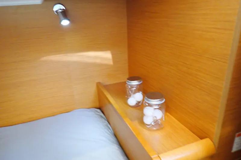 Slide: The Image of Cozy cabin interior of 2018 Jeanneau Sun Odyssey 389 with jars and soft lighting. - 65