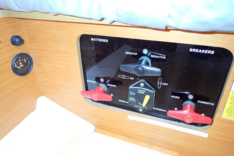 Slide: The Image of Control panel of a 2018 Jeanneau Sun Odyssey 389 sailboat, featuring battery and breaker switches. - 66
