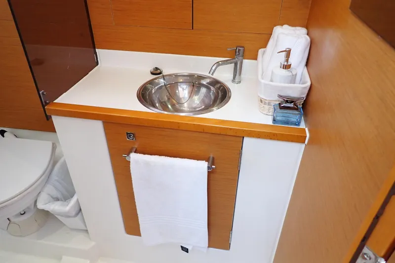 Slide: The Image of 2018 Jeanneau Sun Odyssey 389 bathroom with sink, towel, and toiletries. - 68
