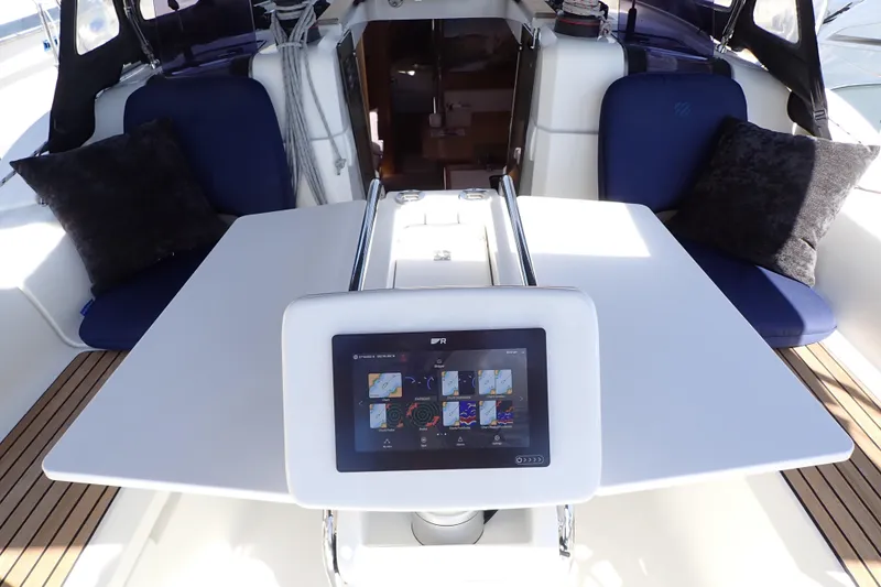 Slide: The Image of Cockpit of 2018 Jeanneau Sun Odyssey 389 with navigation display and seating. - 7