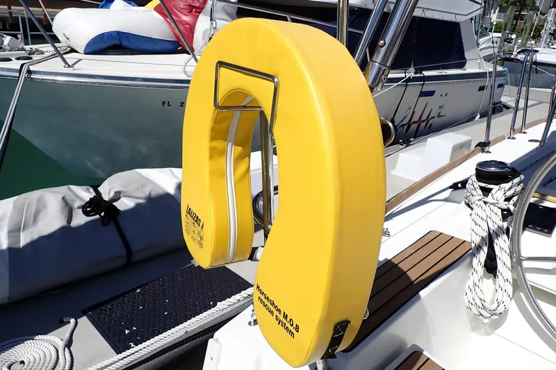 Slide: The Image of Yellow life preserver on Jeanneau Sun Odyssey 389 sailboat deck, 2018 model. - 75