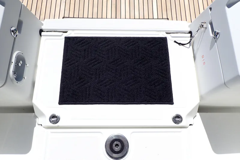 Slide: The Image of 2018 Jeanneau Sun Odyssey 389 yacht deck with black mat and wooden flooring. - 79