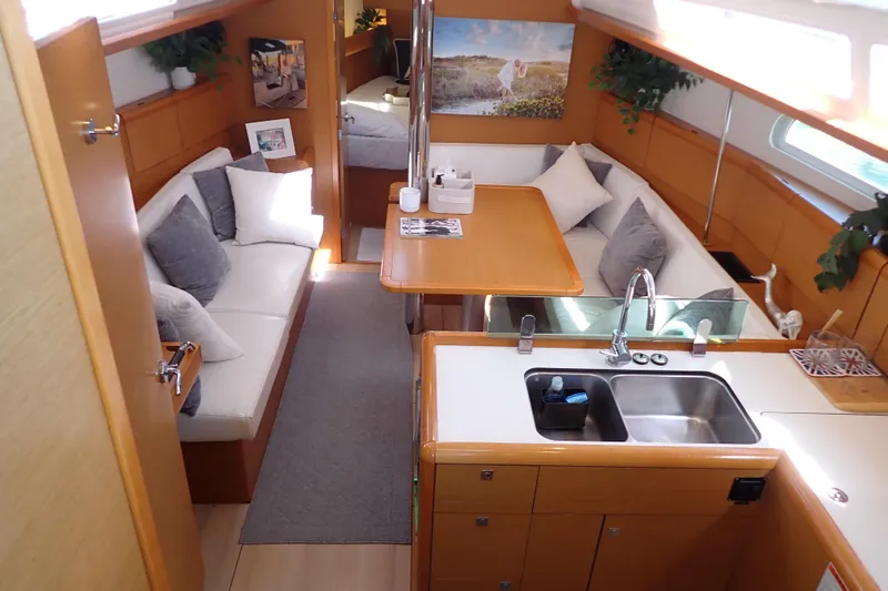 Slide: The Image of Luxurious interior of 2018 Jeanneau Sun Odyssey 389 sailboat with cozy seating and modern kitchen. - 8
