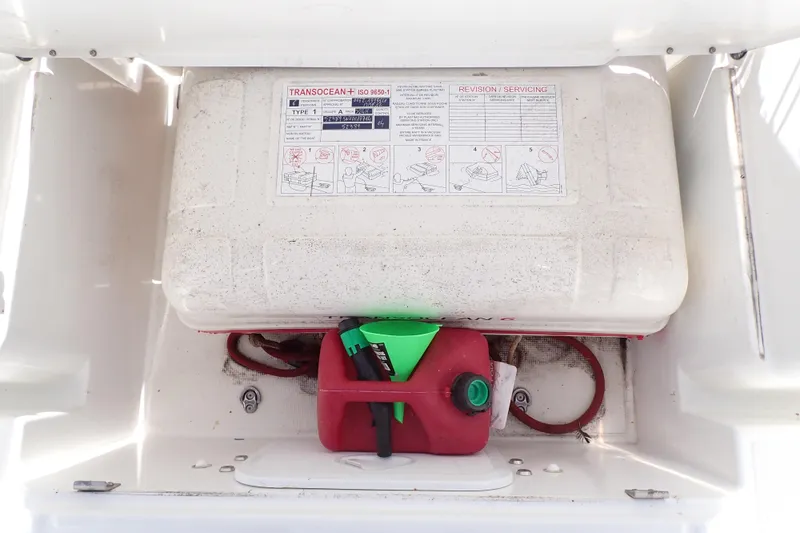 Slide: The Image of Storage compartment on a 2018 Jeanneau Sun Odyssey 389 with safety equipment and fuel container. - 80