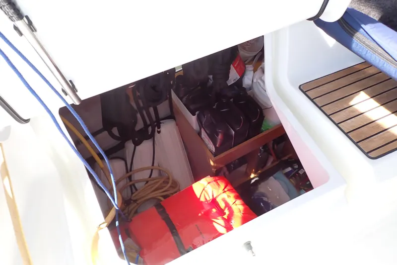 Slide: The Image of Storage compartment of 2018 Jeanneau Sun Odyssey 389 sailboat, containing ropes and equipment. - 90