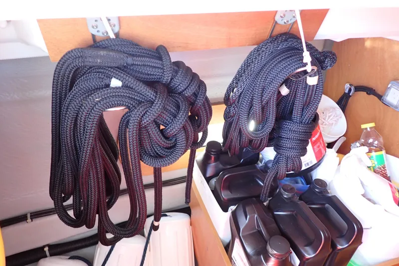 Slide: The Image of Coiled ropes and supplies in Jeanneau Sun Odyssey 389 sailboat storage, 2018 model. - 93