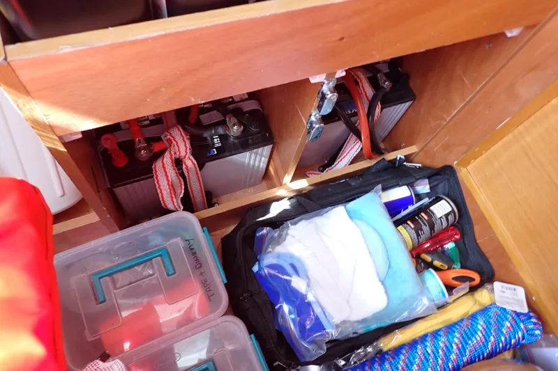 Slide: The Image of Storage compartment in a 2018 Jeanneau Sun Odyssey 389, featuring batteries and maintenance supplies. - 94