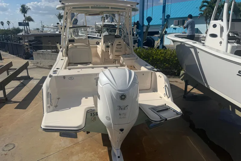 Slide: The Image of 2023 Grady-White Freedom 235 boat with Yamaha outboard motor, docked under sunny skies. - 10