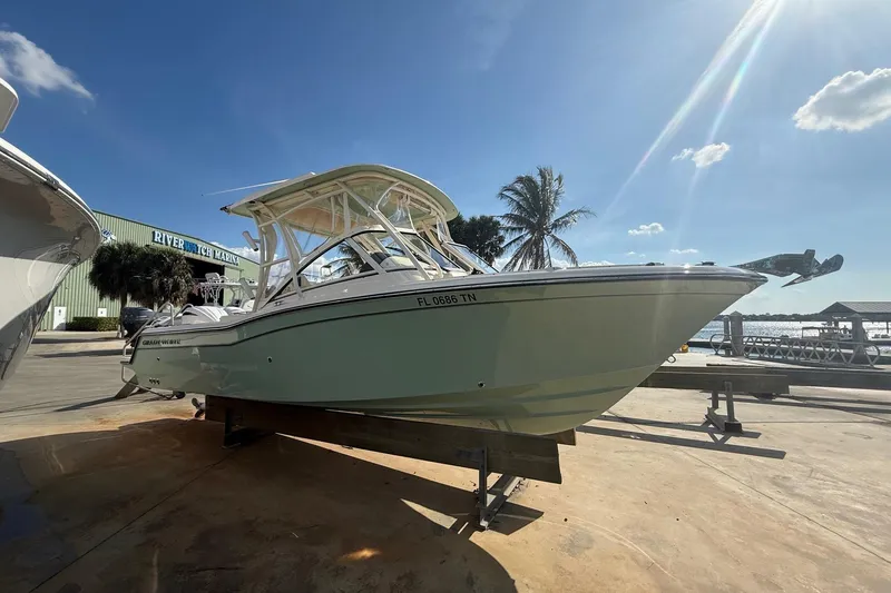 Slide: The Image of 2023 Grady-White Freedom 235 boat at River Watch Marina under sunny skies. - 2