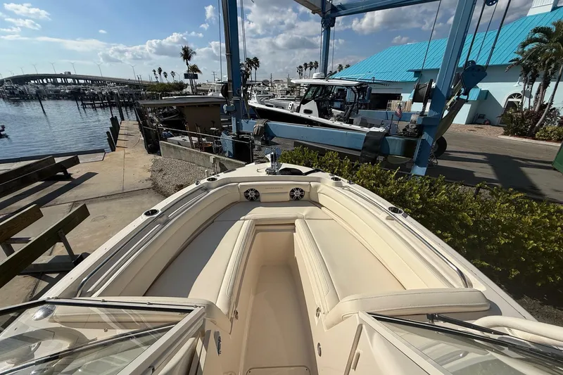 Slide: The Image of 2023 Grady-White Freedom 235 boat docked at marina with clear skies. - 7