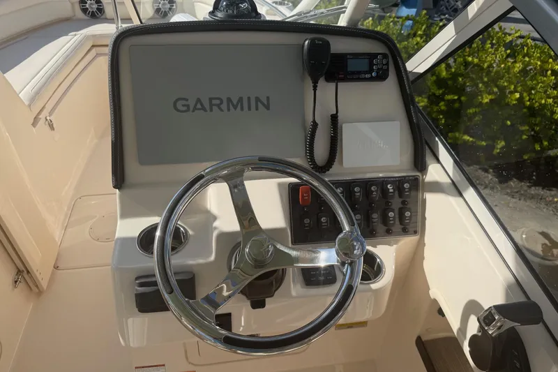Slide: The Image of 2023 Grady-White Freedom 235 helm with Garmin navigation and control panel. - 8