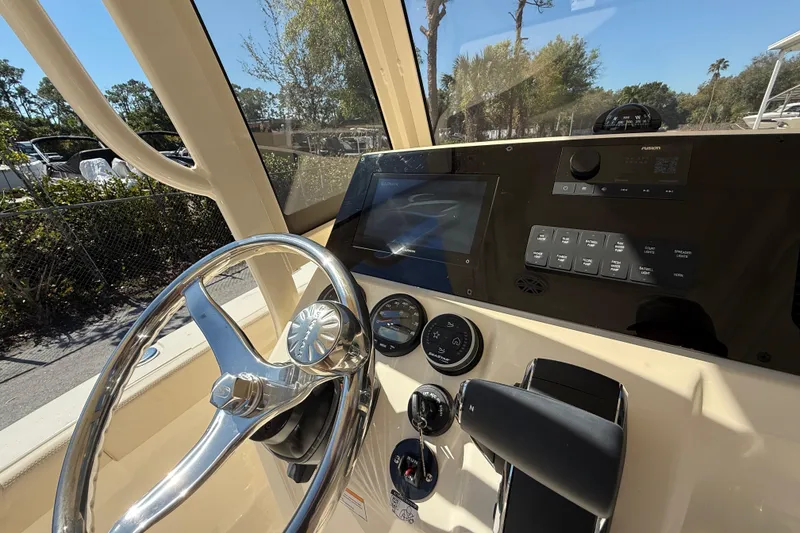 Slide: The Image of 2026 Scout 220 XSF boat dashboard with steering wheel and control panel. - 12
