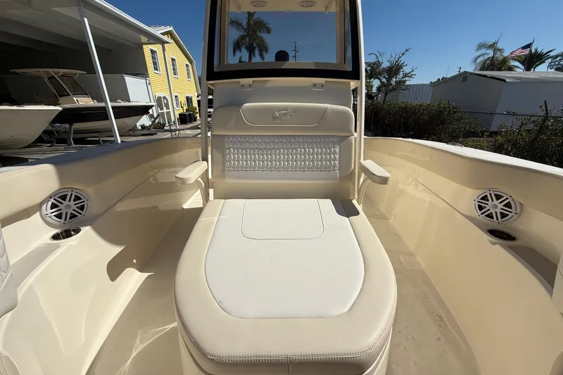Slide: The Image of 2026 Scout 220 XSF boat interior with cushioned seating and speaker system. - 16