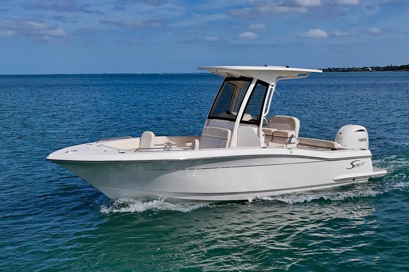 Slide: The Image of 2026 Scout 220 XSF boat cruising on clear blue water under a sunny sky. - 21