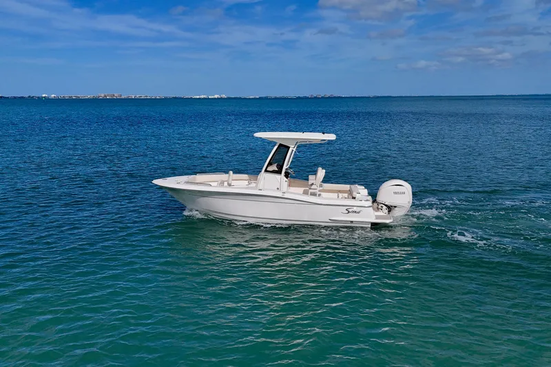 Slide: The Image of 2026 Scout 220 XSF boat cruising on clear blue ocean waters. - 24