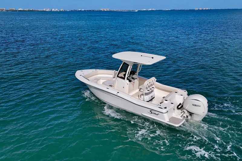 Slide: The Image of 2026 Scout 220 XSF boat cruising on clear blue ocean waters. - 25