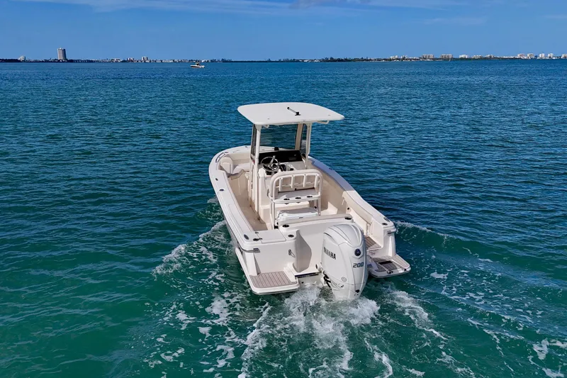 Slide: The Image of 2026 Scout 220 XSF boat cruising on clear blue water. - 26