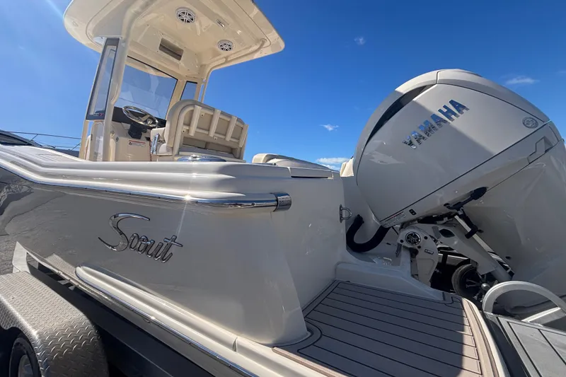 Slide: The Image of 2026 Scout 220 XSF boat with Yamaha engine, sleek design under clear blue sky. - 4