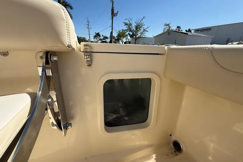Slide: The Image of 2026 Scout 220 XSF boat interior detail with storage compartment and seating. - 6