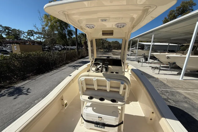 Slide: The Image of 2026 Scout 220 XSF boat interior with helm, seating, and console under canopy. - 8