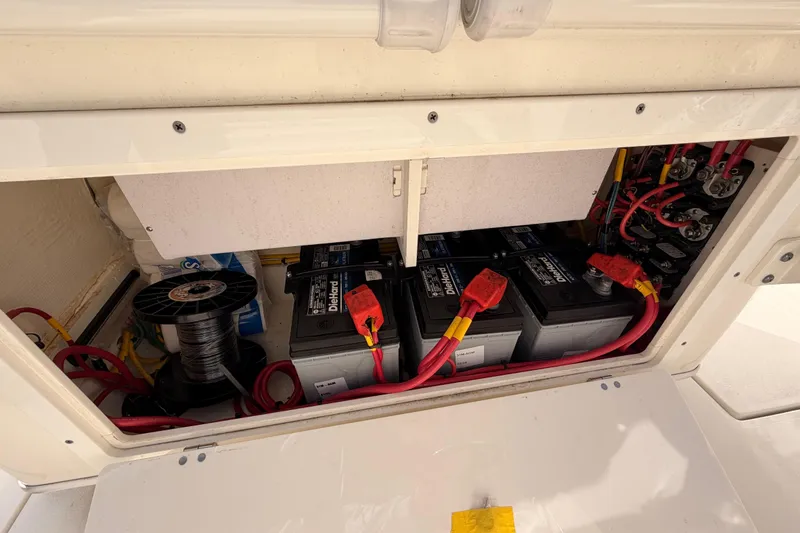 Slide: The Image of 2024 Cobia 262 Center Console battery compartment with wiring and components. - 16