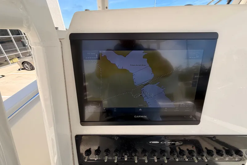 Slide: The Image of 2024 Cobia 262 Center Console with Garmin navigation display showing map. - 19