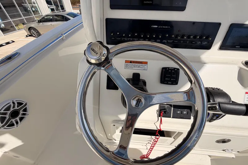 Slide: The Image of 2024 Cobia 262 Center Console boat steering wheel and control panel. - 20