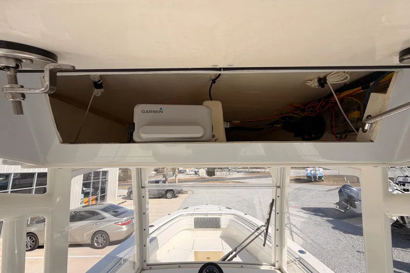 Slide: The Image of 2024 Cobia 262 Center Console boat with Garmin electronics and open storage compartment. - 23
