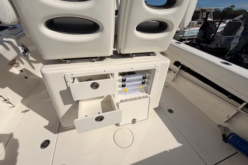 Slide: The Image of 2024 Cobia 262 Center Console boat interior with open storage compartments. - 27