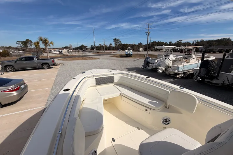 Slide: The Image of 2024 Cobia 262 Center Console boat in a parking lot with clear blue sky. - 8