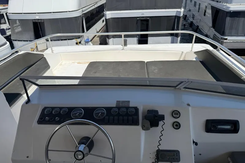 Slide: The Image of 2004 Sharpe Houseboat San Juan Sunrise Share #30 helm with controls and seating area. - 15